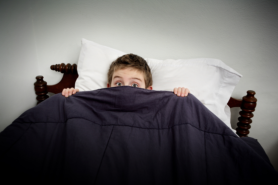 bigstock-Boy-hiding-in-bed-under-the-co-40815694