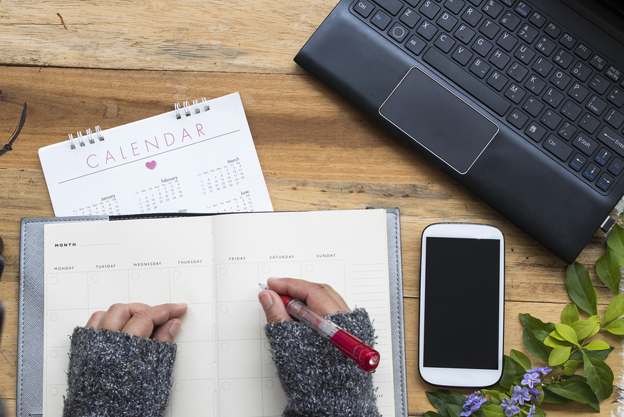 Women with planner, calendar and laptop