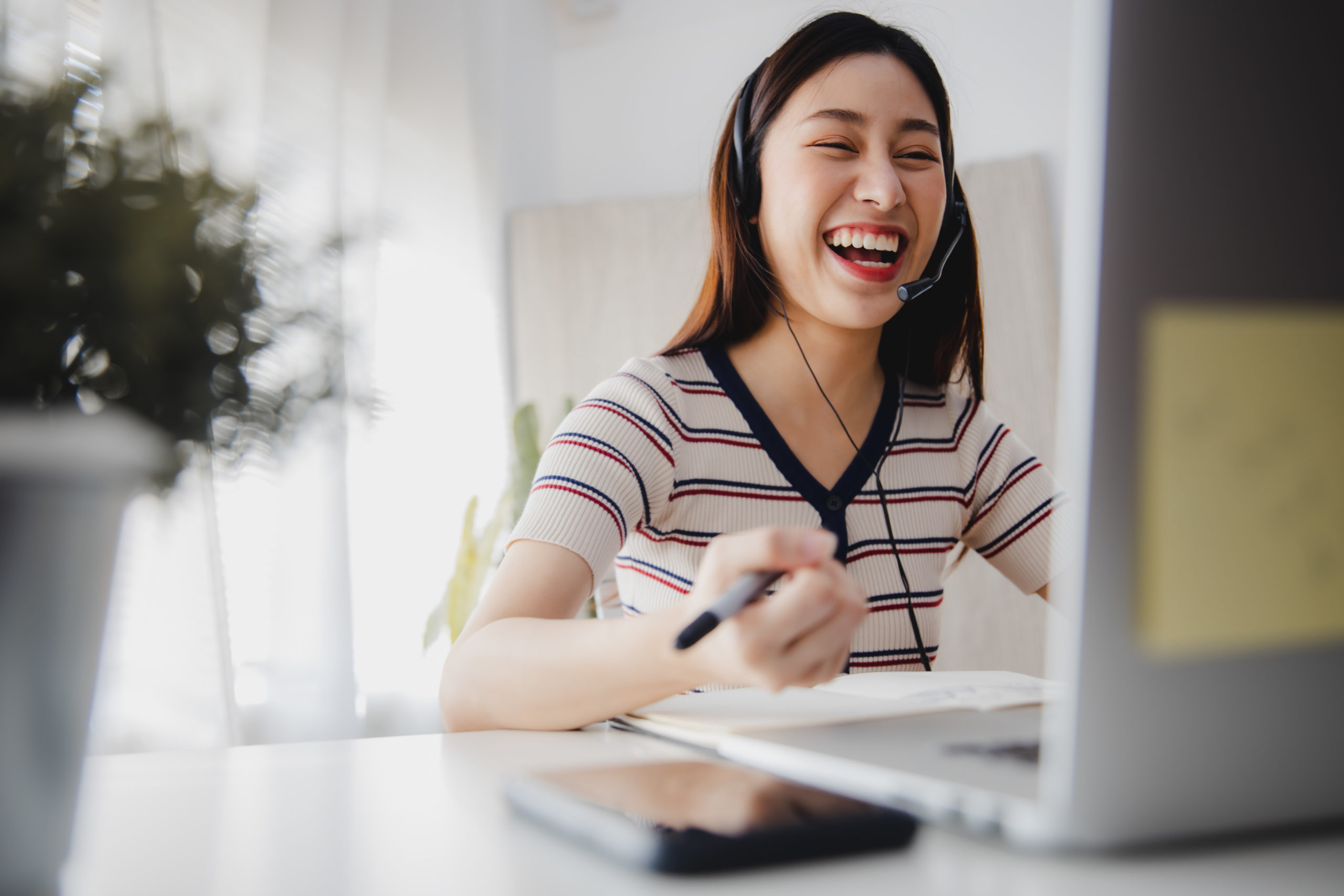 woman at a computer laughing during nonprofit communications training