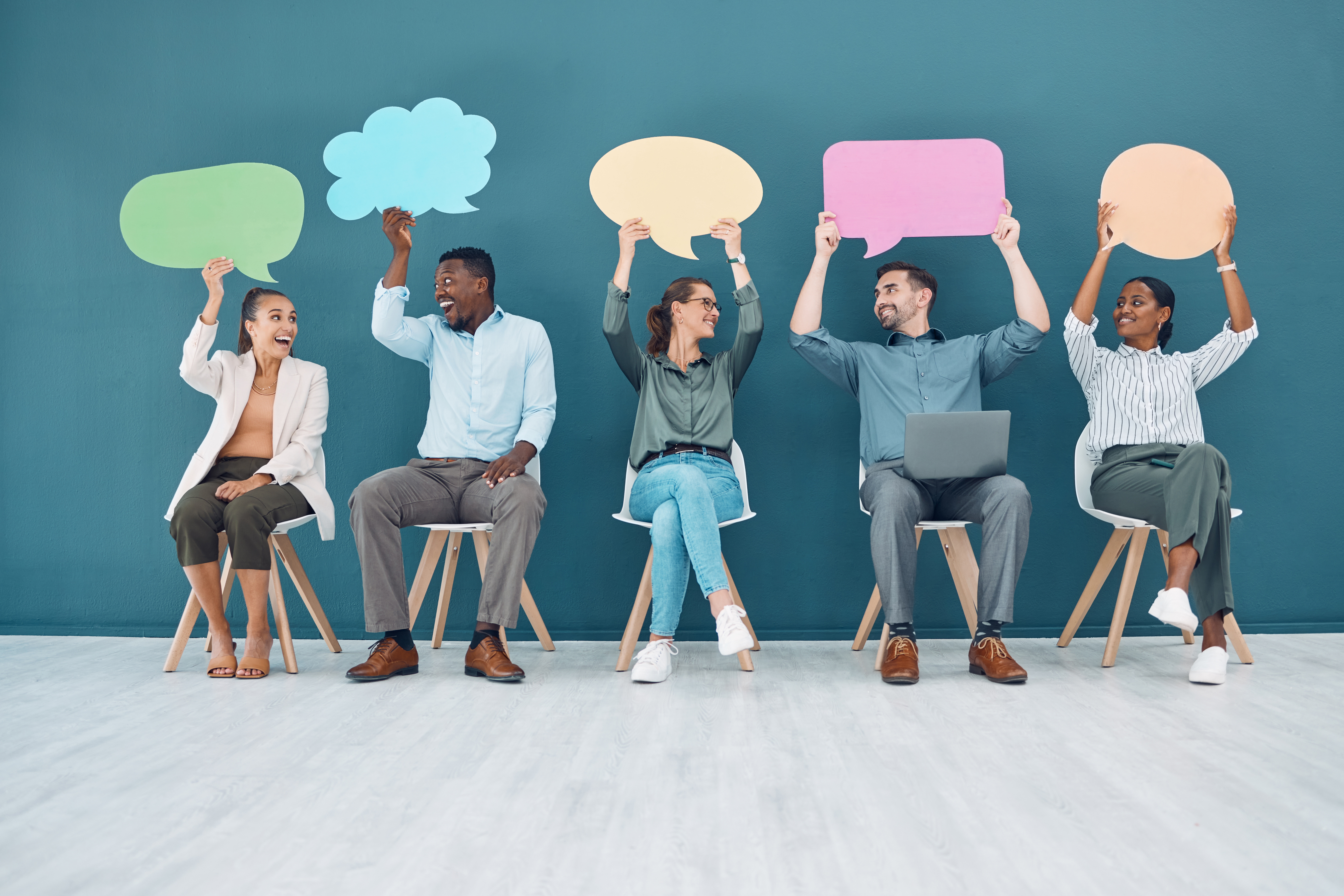 five people sitting in chairs holding speech bubble over their heads as a metaphor for sharing zero-party data about themselves