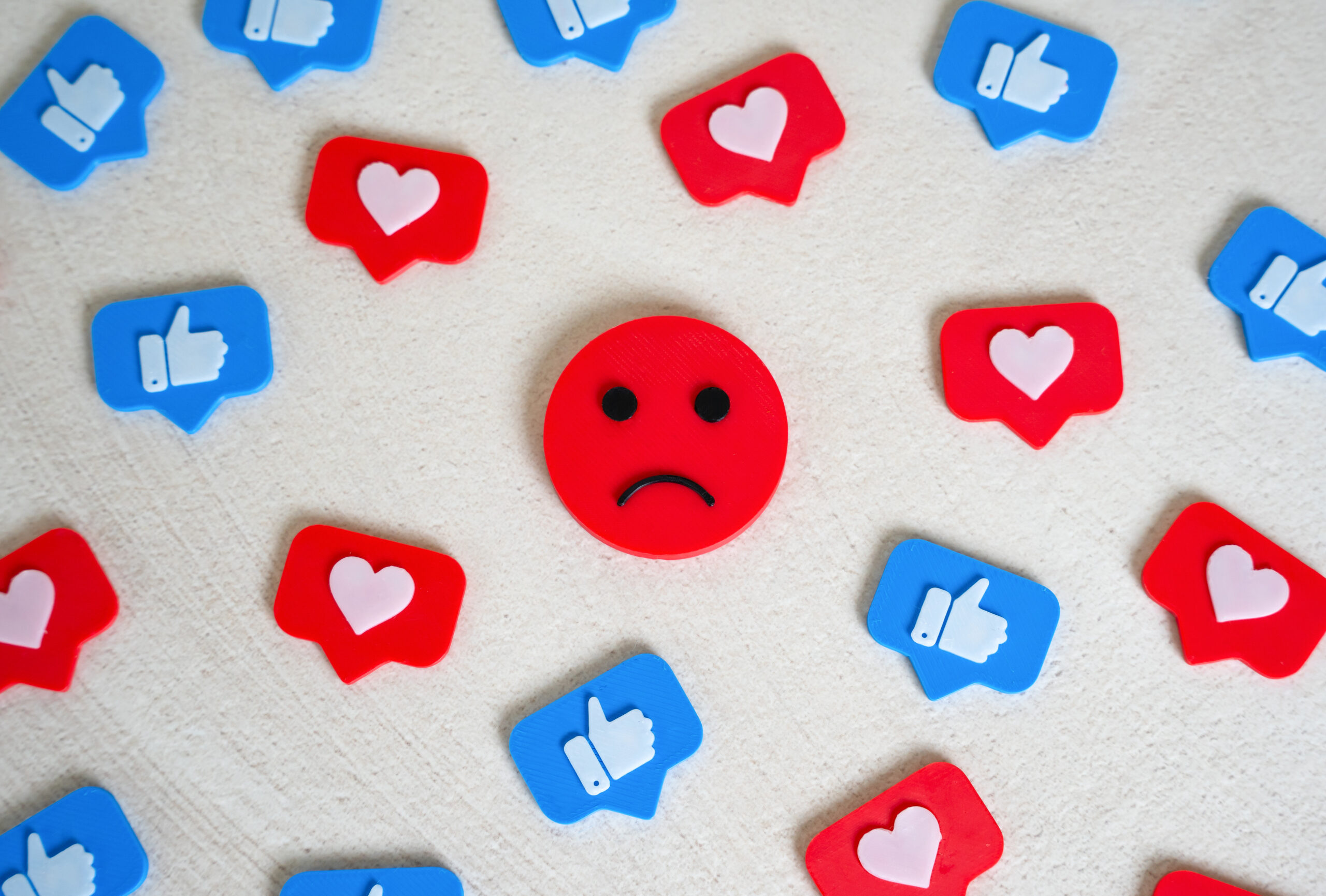 Sad face among social media likes. Burnout and doomscrolling. Chasing likes, social media addiction